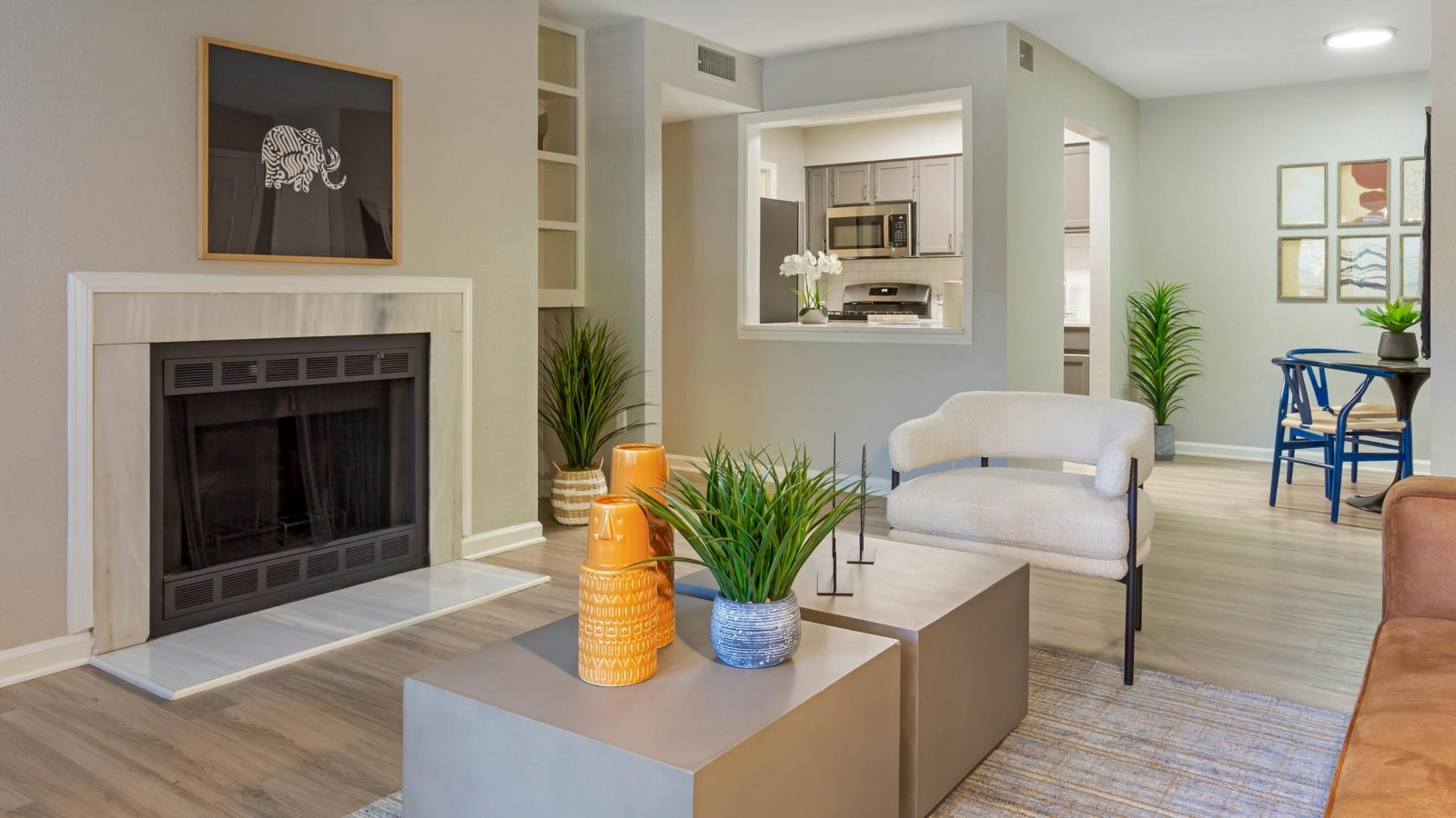 a living room with a fireplace and a couch at The  Hargrove at Southpoint