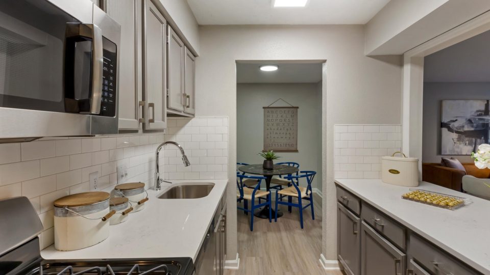 kitchen with stainless steel appliances and white cabinets at The Hargrove at Southpoint