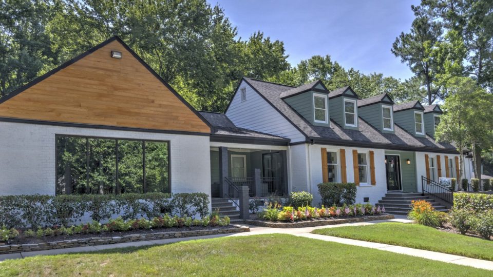 a home with a white exterior and green trim at The  Hargrove at Southpoint