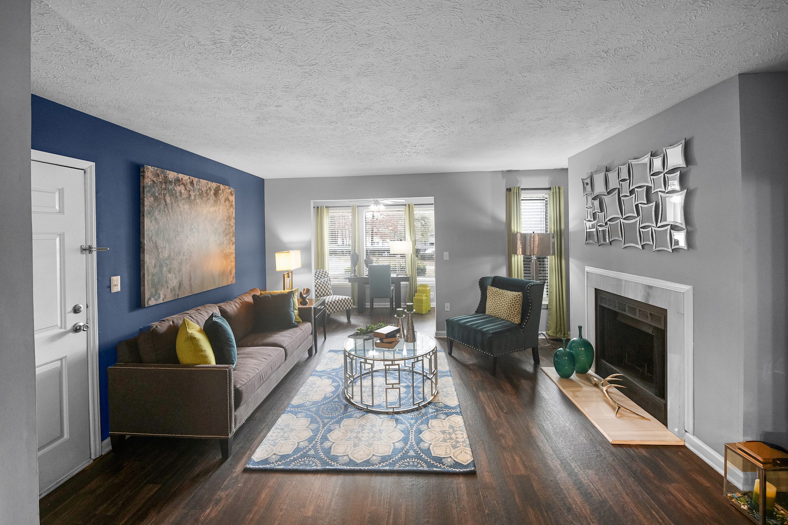 a living room with blue walls and hardwood floors at The  Hargrove at Southpoint