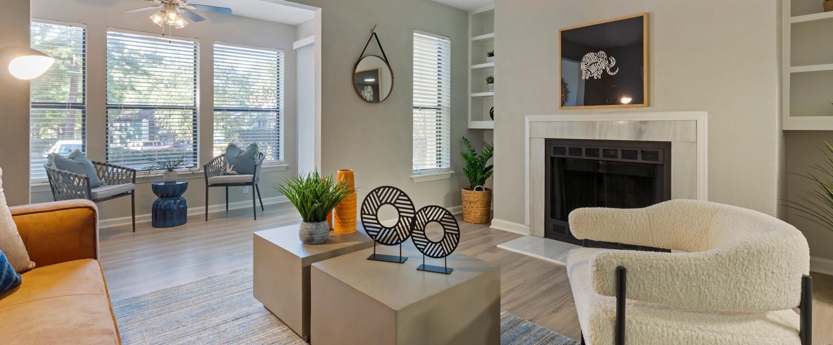 a living room with a fireplace and a couch at The  Hargrove at Southpoint