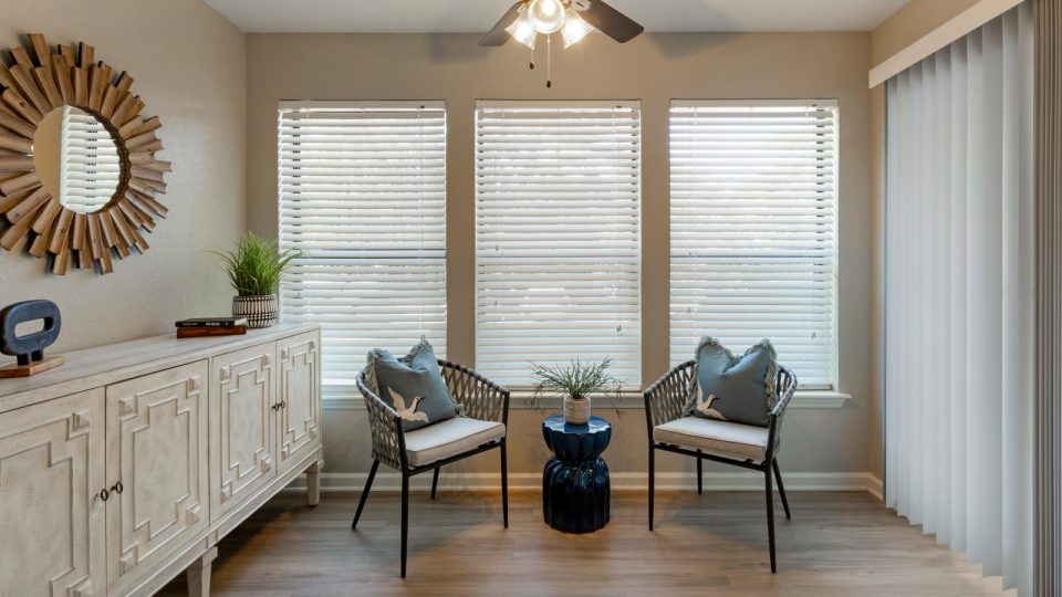 a living room with two chairs and a window at The Hargrove at Southpoint