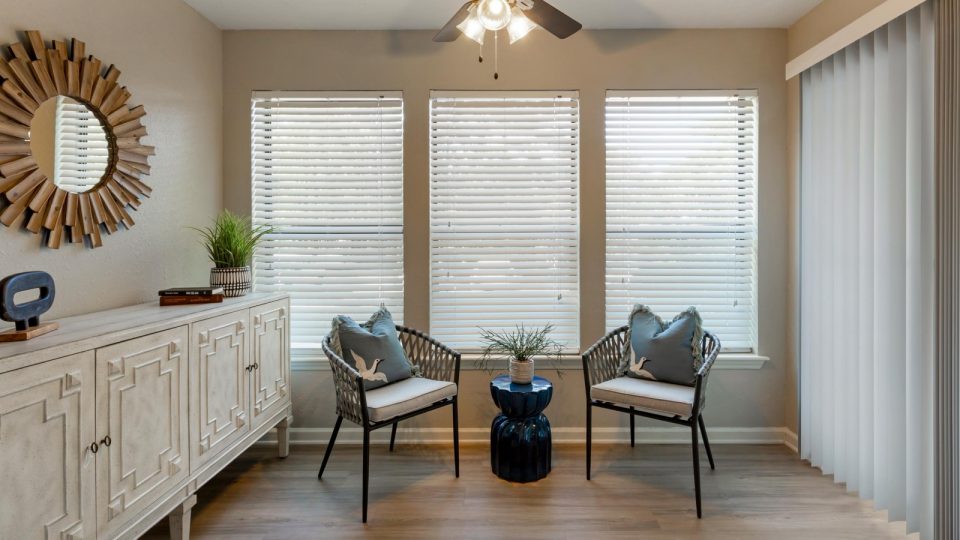 a living room with two chairs and a window at The  Hargrove at Southpoint