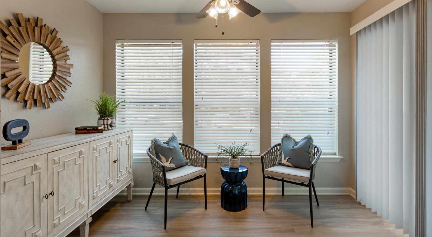 a living room with two chairs and a window at The  Hargrove at Southpoint