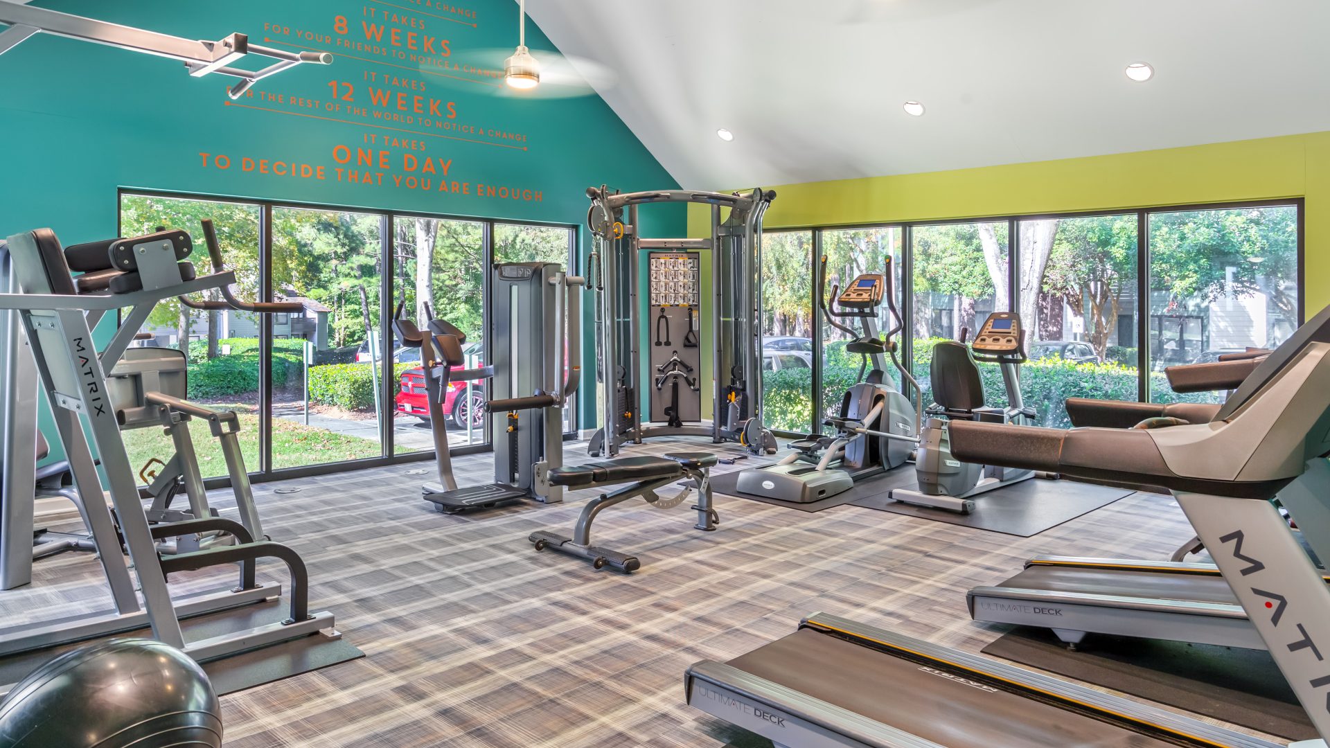 a gym room with treadmills, weights and other equipment at The  Hargrove at Southpoint